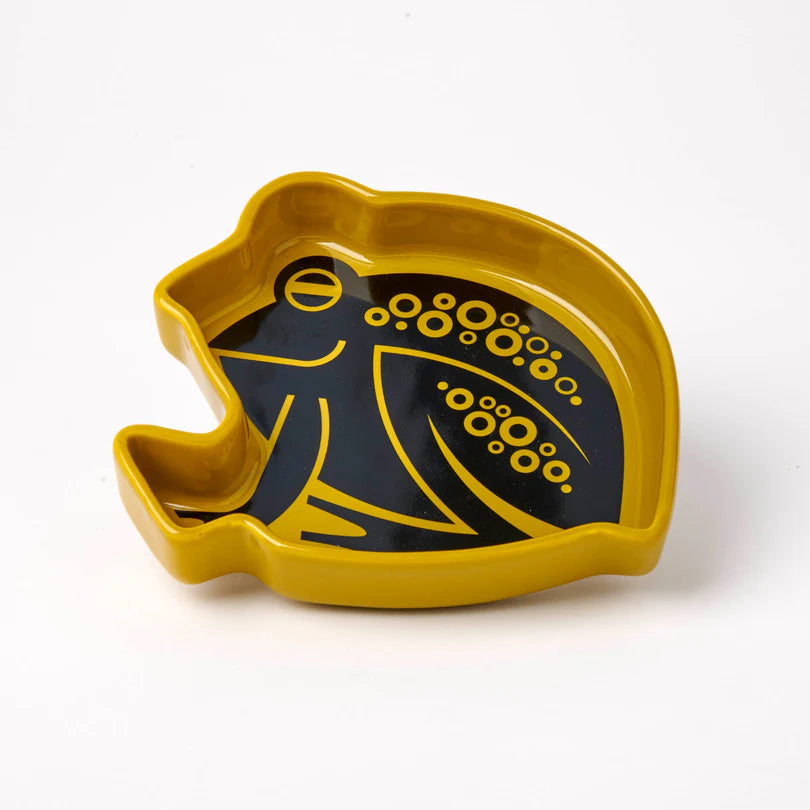 Yellow and black frog-shaped dish on a white background