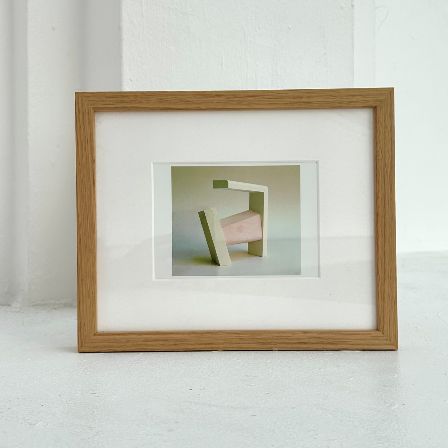 Framed artwork with abstract sculptural design on a white background