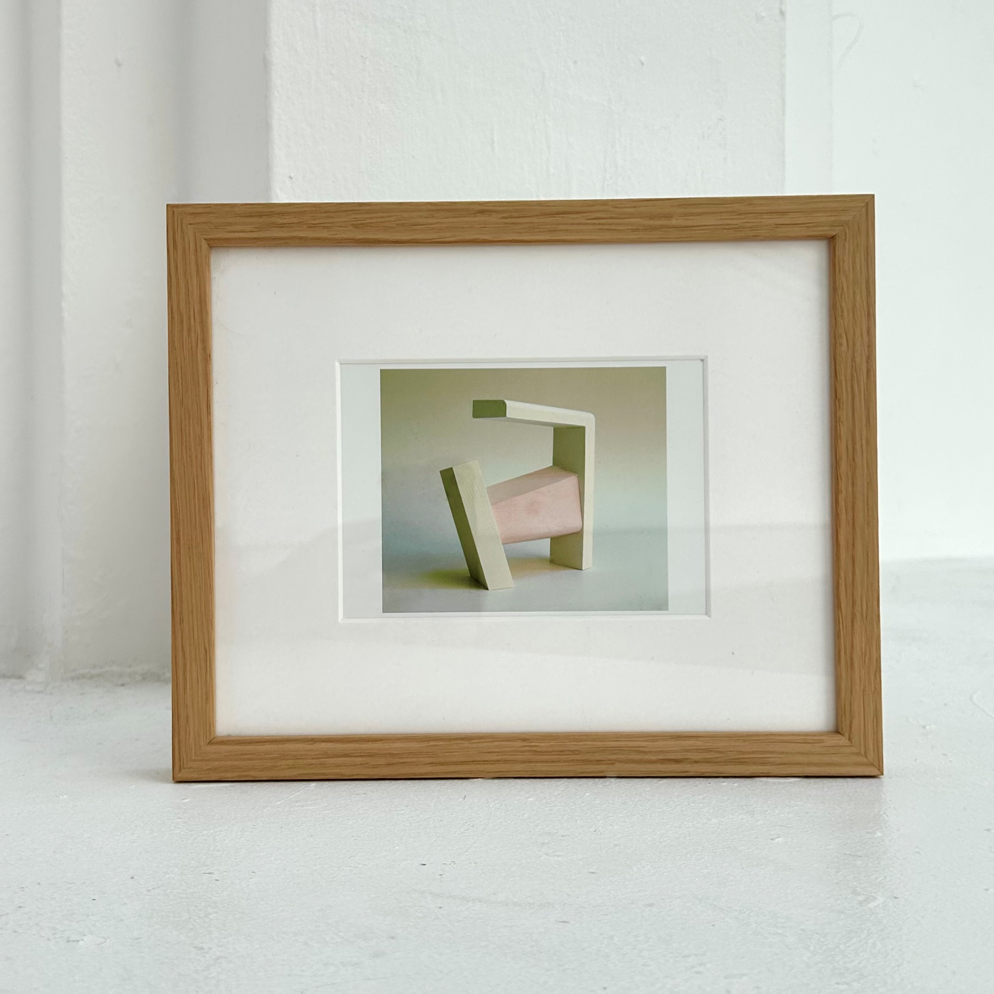Framed artwork with abstract sculptural design on a white background