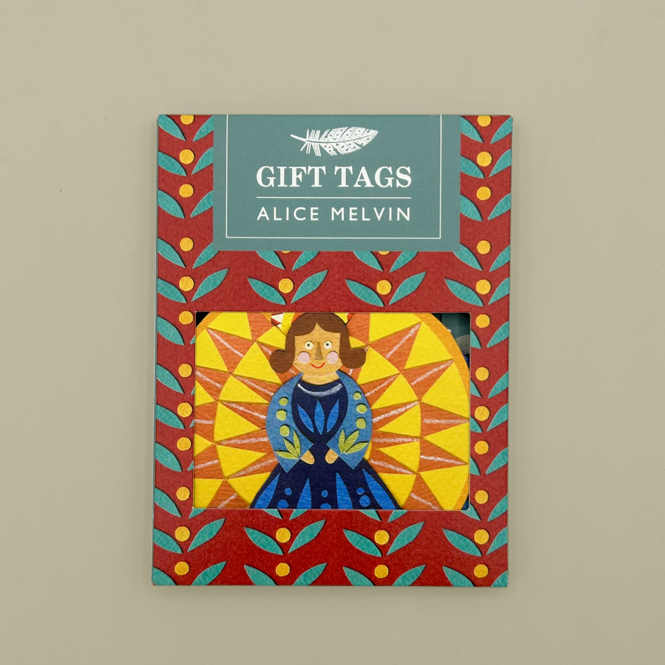 Alice Melvin gift tags featuring a colorful illustration of a girl in a blue dress on a yellow sunburst background, set within a red patterned packet with a teal header card.