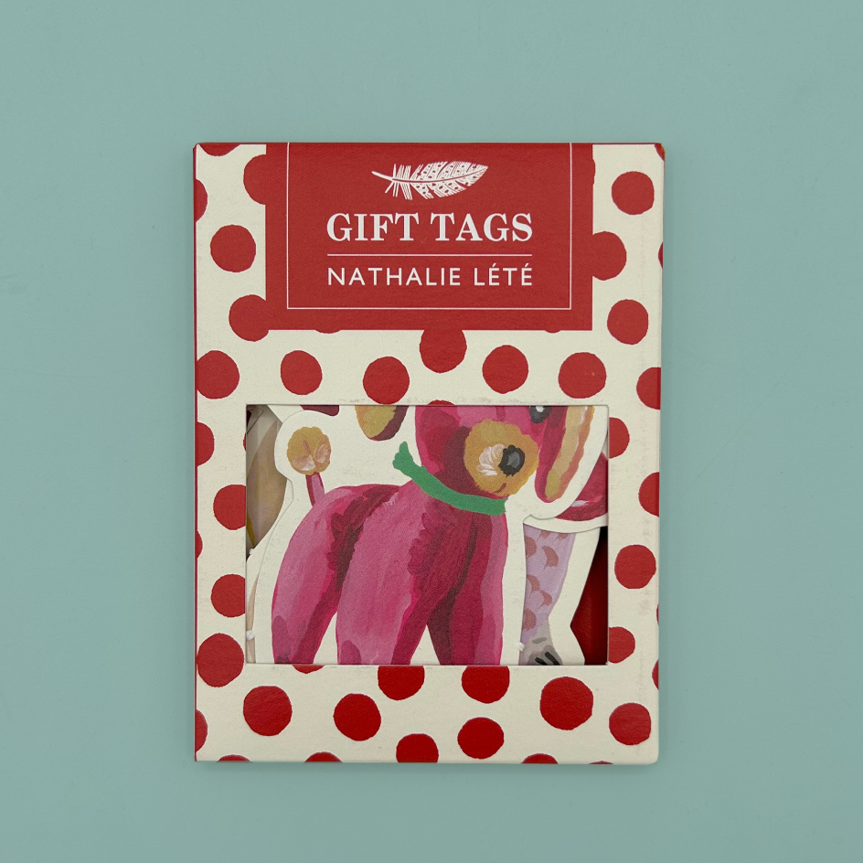 The packaging for a set of gift tags, made out of card with a white background and red dots. It features a feather and text stating 'GIFT TAGS' and 'Nathalie Lété'.