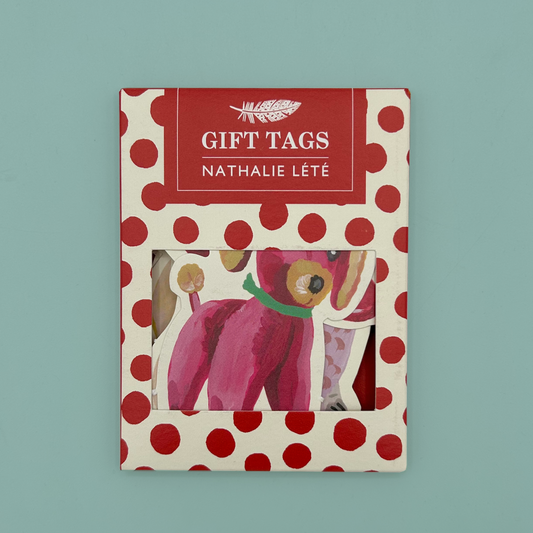 The packaging for a set of gift tags, made out of card with a white background and red dots. It features a feather and text stating 'GIFT TAGS' and 'Nathalie Lété'.