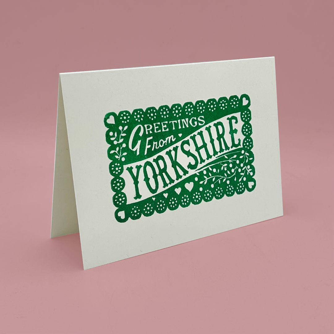 Greeting card with 'Greetings from Yorkshire' text on a pink background