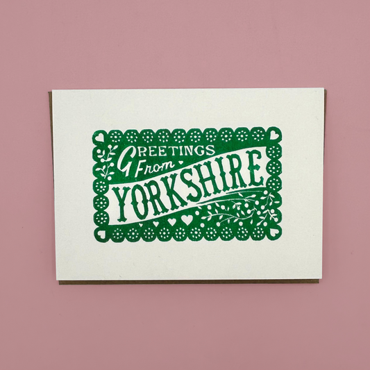 Card with 'Greetings from Yorkshire' text on a pink background