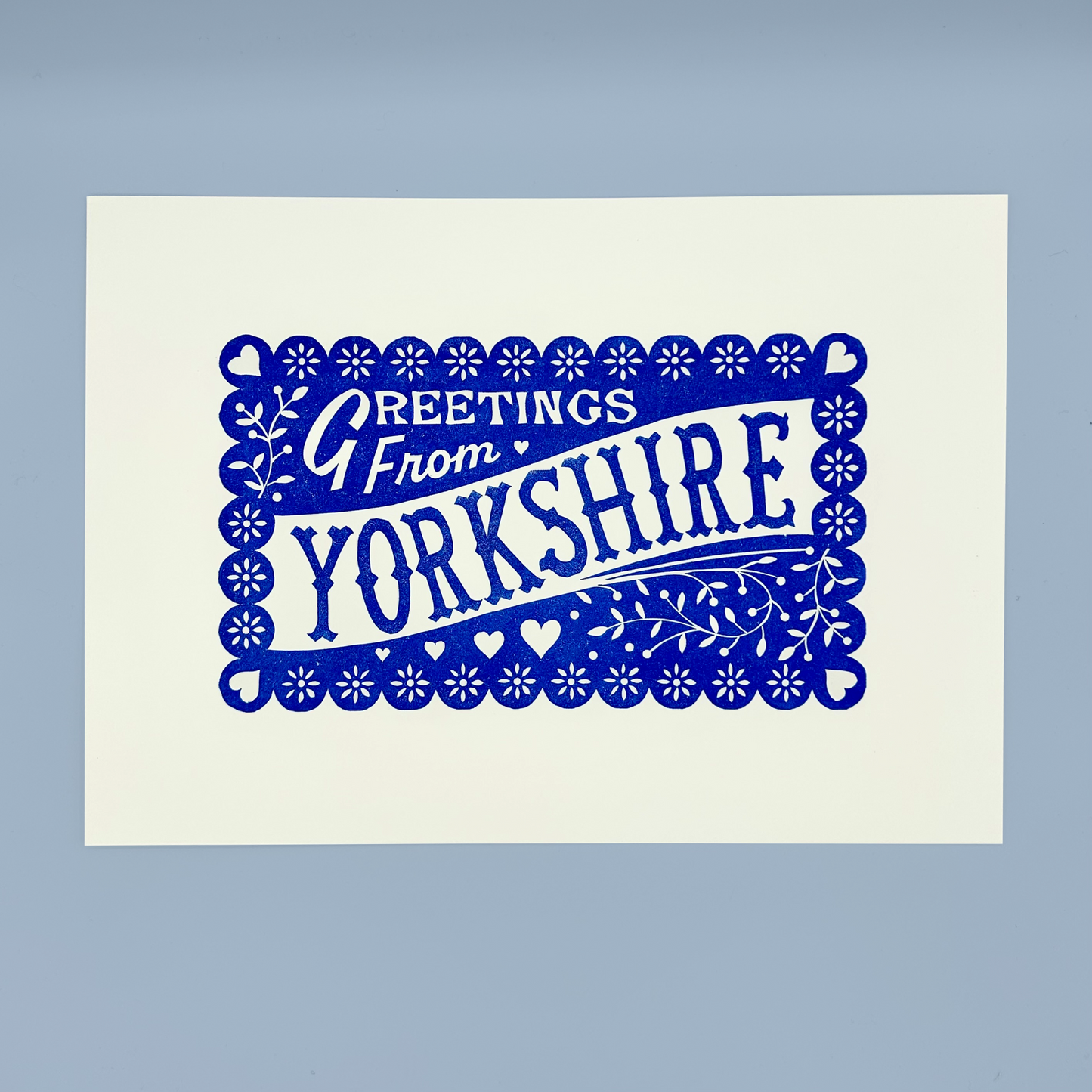 Print with 'Greetings from Yorkshire' text in blue on a white background