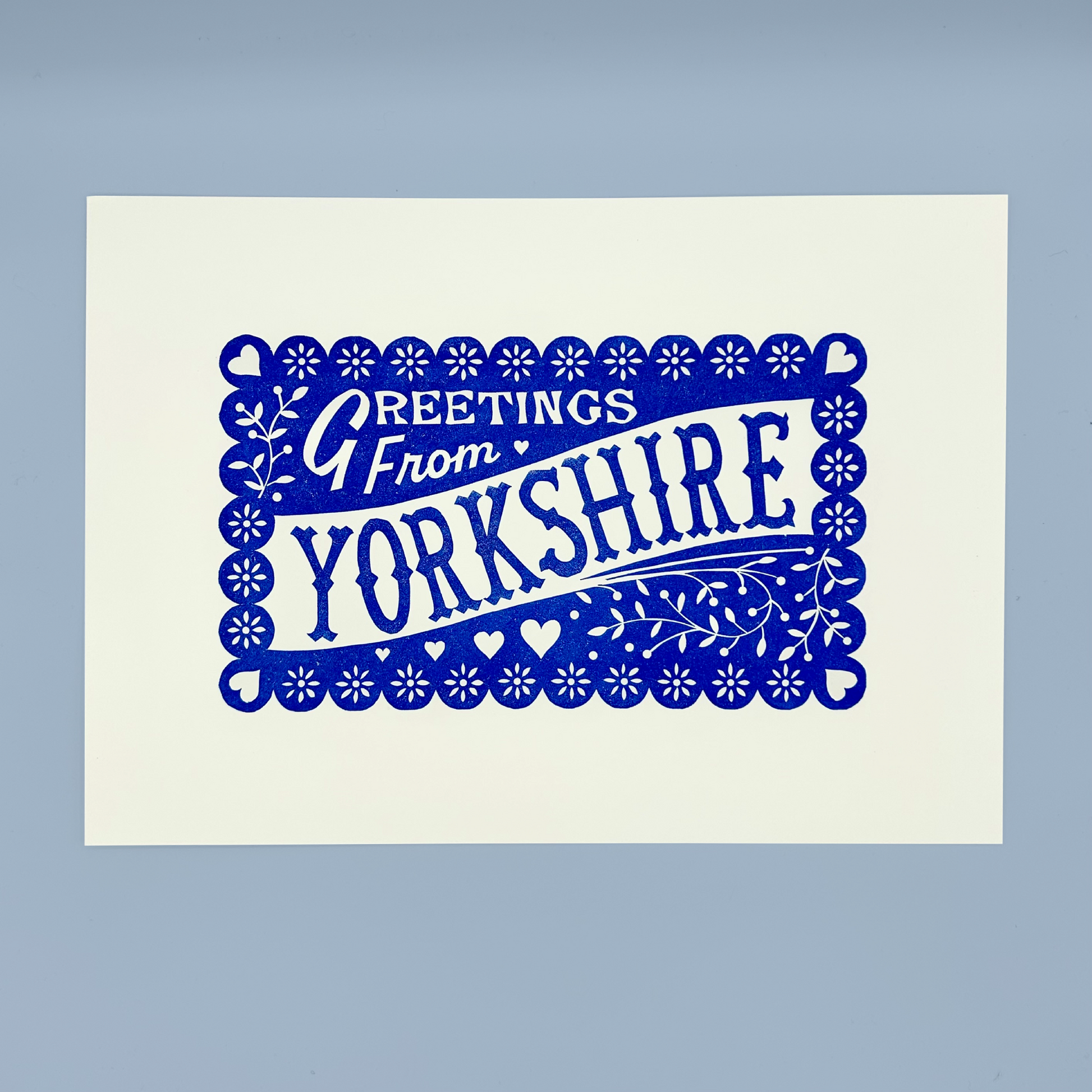 Print with 'Greetings from Yorkshire' text in blue on a white background