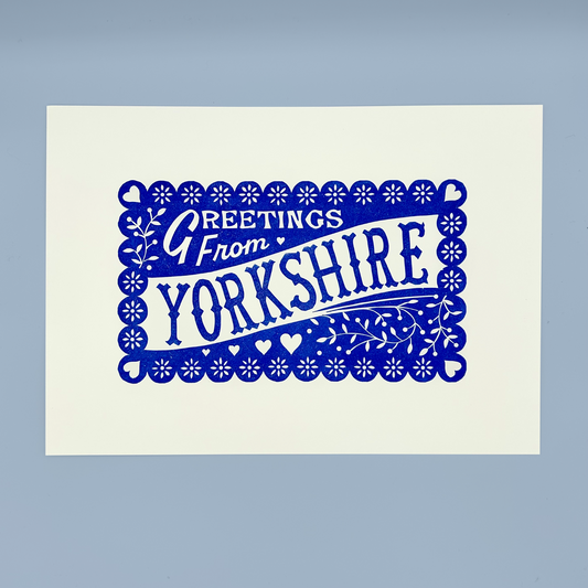 Print with 'Greetings from Yorkshire' text in blue on a white background