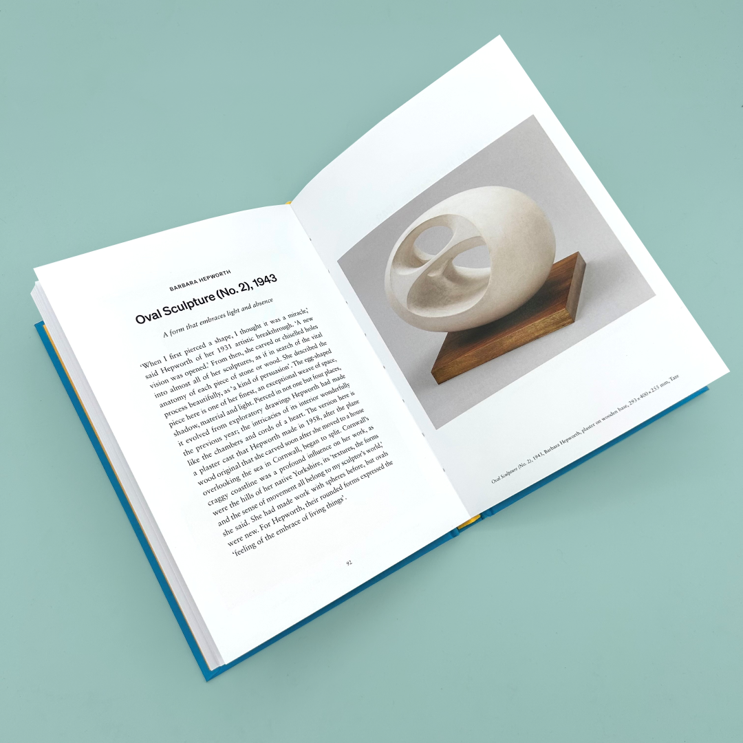 Open book with a sculpture on a stand and text on a light blue background