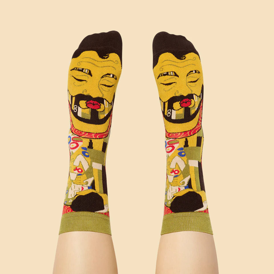 Colorful socks with a stylized face design on a beige background