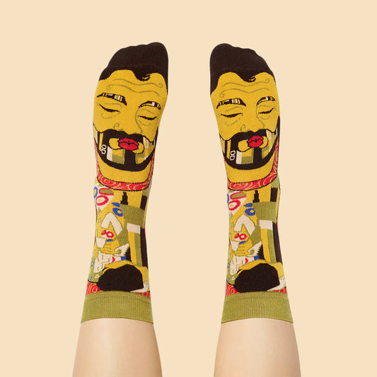 Colorful socks with a stylized face design on a beige background