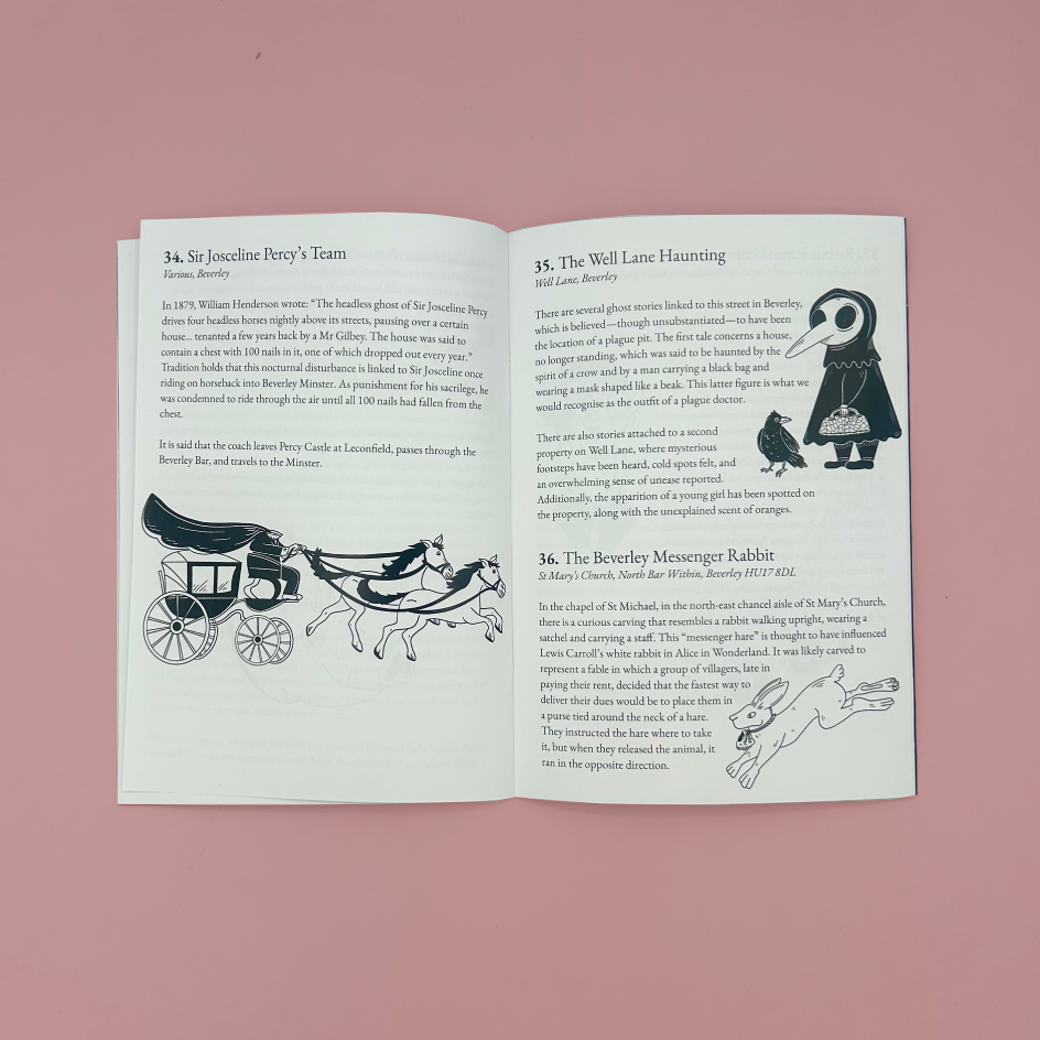 An open book spread showing three illustrated history pages with black text and drawings, photographed against a solid dusty pink background.