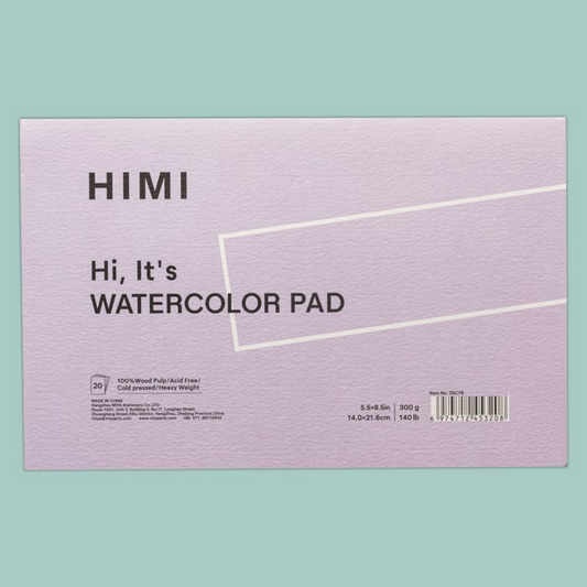 A HIMI watercolor pad with a textured lavender cover, displayed against a solid mint green background.
