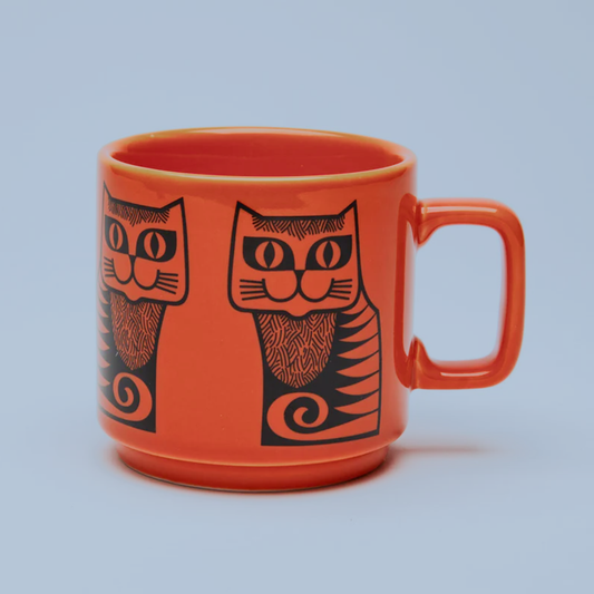 Orange mug with black cat illustrations on a light blue background