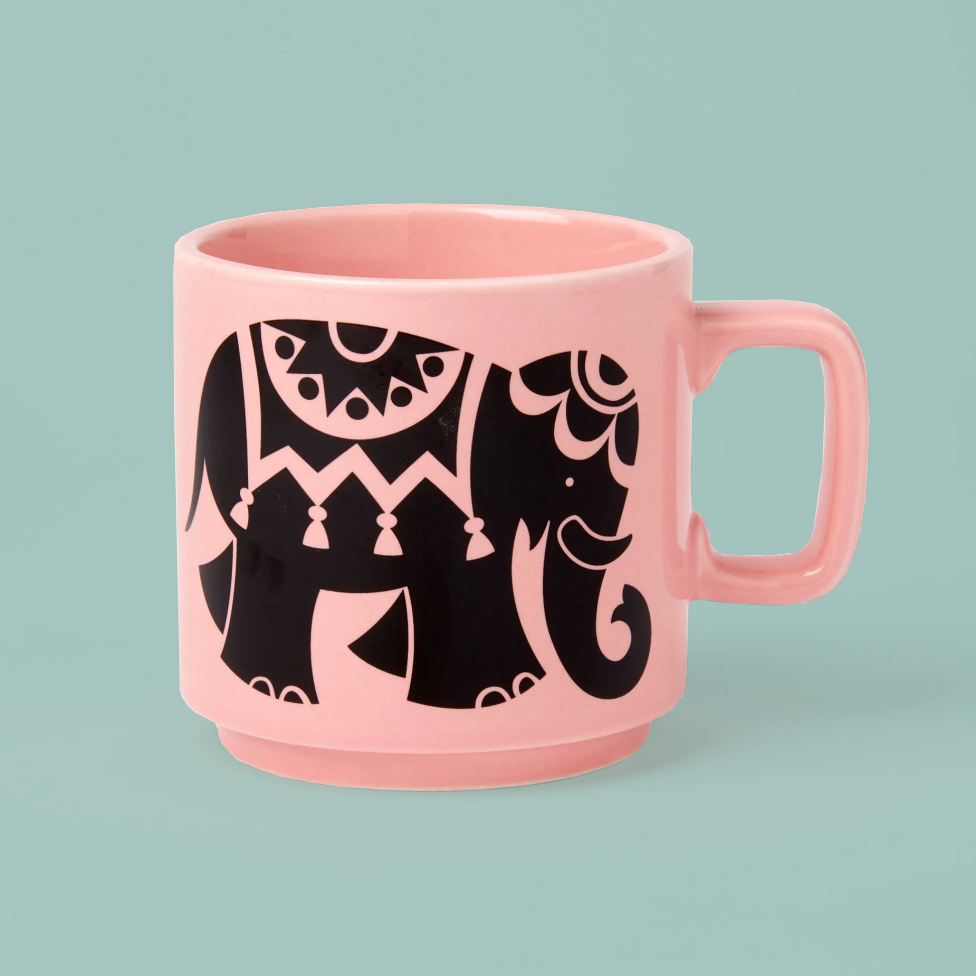 Pink mug with black elephant design on a light blue background