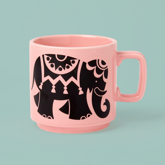 Pink mug with black elephant design on a light blue background