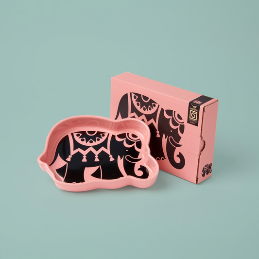 Pink elephant-shaped trinket tray with black design on a light blue background