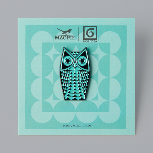 A teal-colored enamel pin with a geometric pattern and an owl design, packaged on a matching teal backing card with the brand name 'Magpie' and 'Hornsea' mentioned.