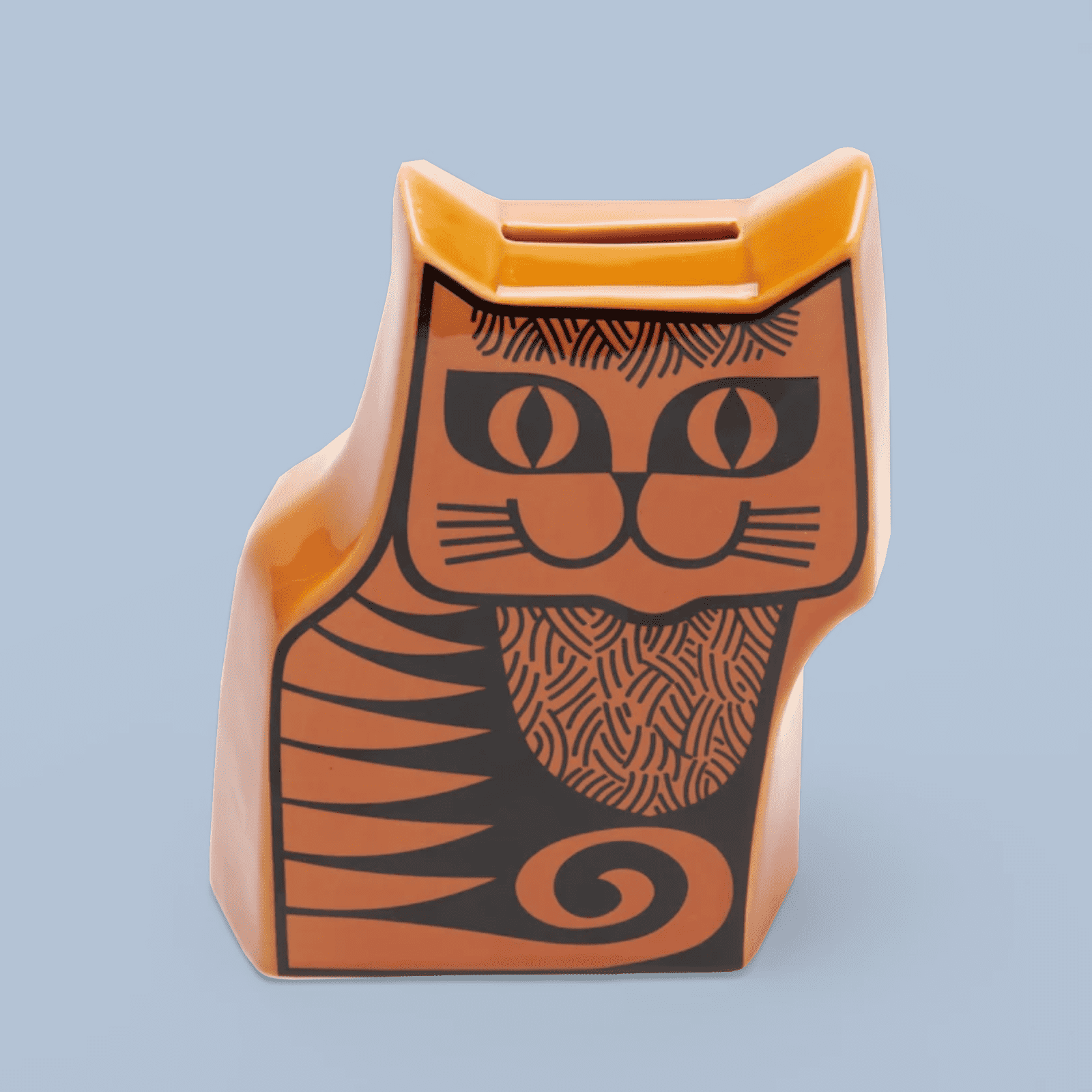 Cat shaped money box with a black and orange design.