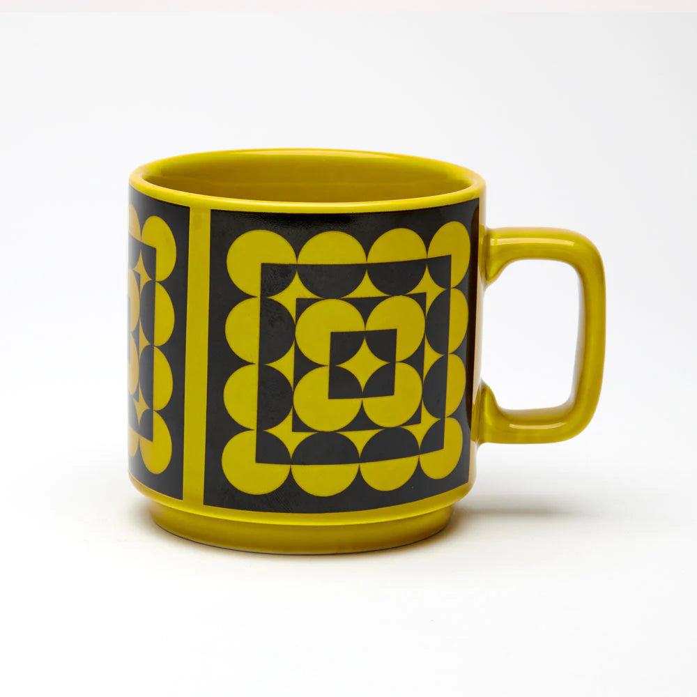 Yellow mug with geometric pattern on a white background