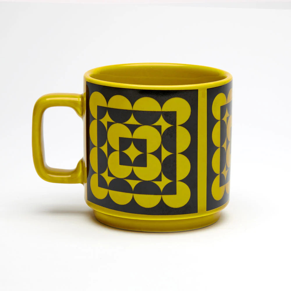 Yellow mug with geometric pattern on a white background