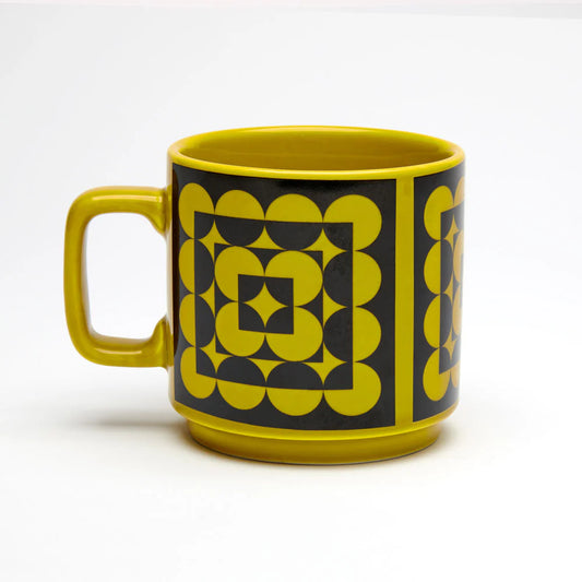 Yellow mug with geometric pattern on a white background