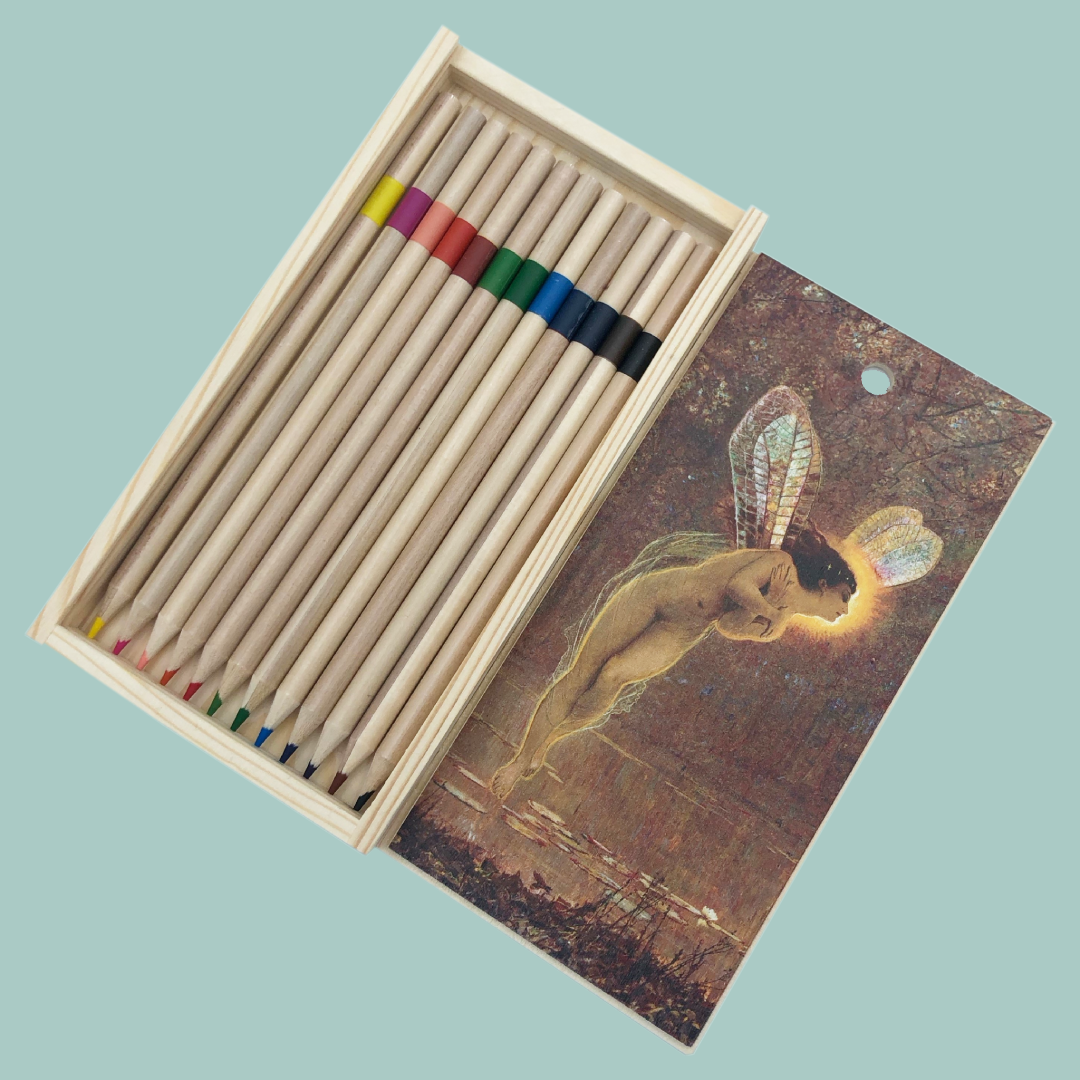 Set of colored pencils in a wooden box with an image of Iris by Atkinson Grimshaw, on a light blue background