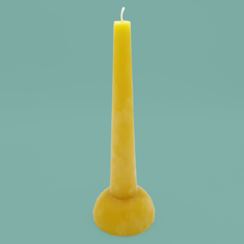 Yellow candle with a curved base.