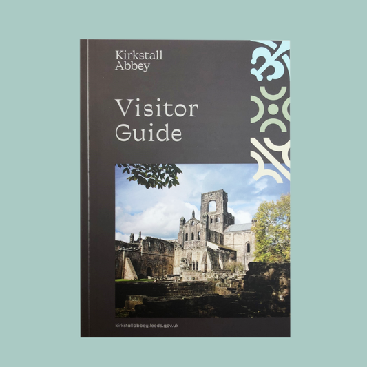 A cover image of the 'Kirkstall Abbey Visitor Guide', featuring a photo of the Kirkstall Abbey ruins with a clear sky in the background.