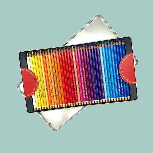 Set of colored pencils in a metal case on a light blue background