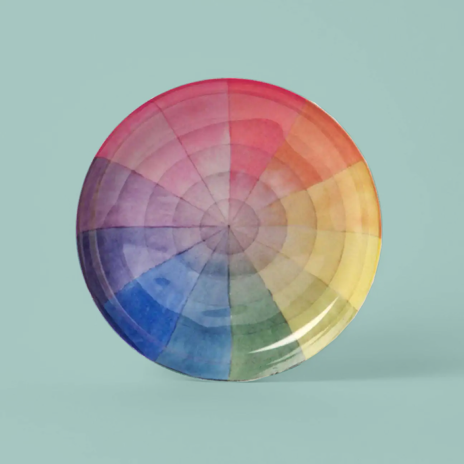 A round enamel tray  featuring a  rainbow color wheel design, displayed against a solid light teal background.