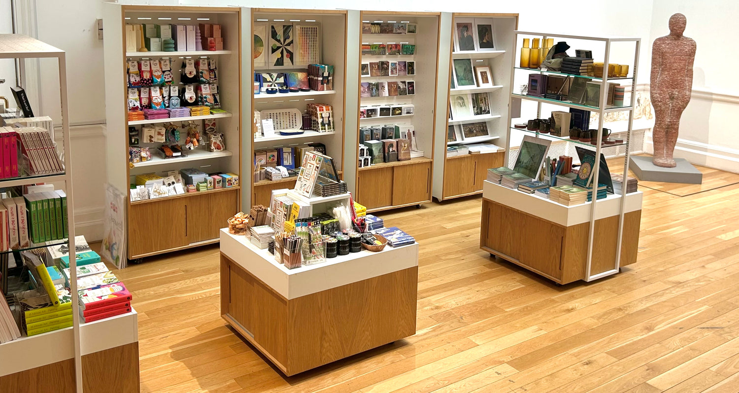 Store interior with bookshelves and display units on a wooden floor