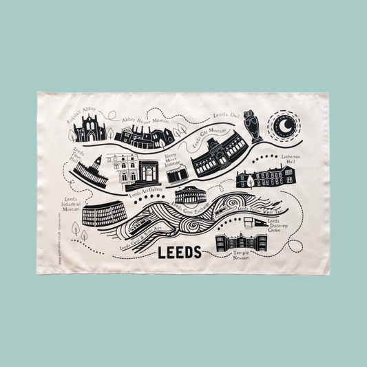 Tea towel with a map of Leeds featuring landmarks on a teal background. 