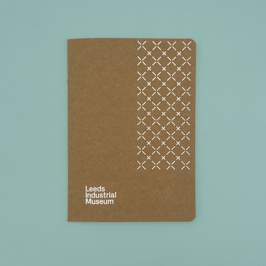 A brown kraft sketchbook with 'Leeds Industrial Museum' branding, on a teal background.