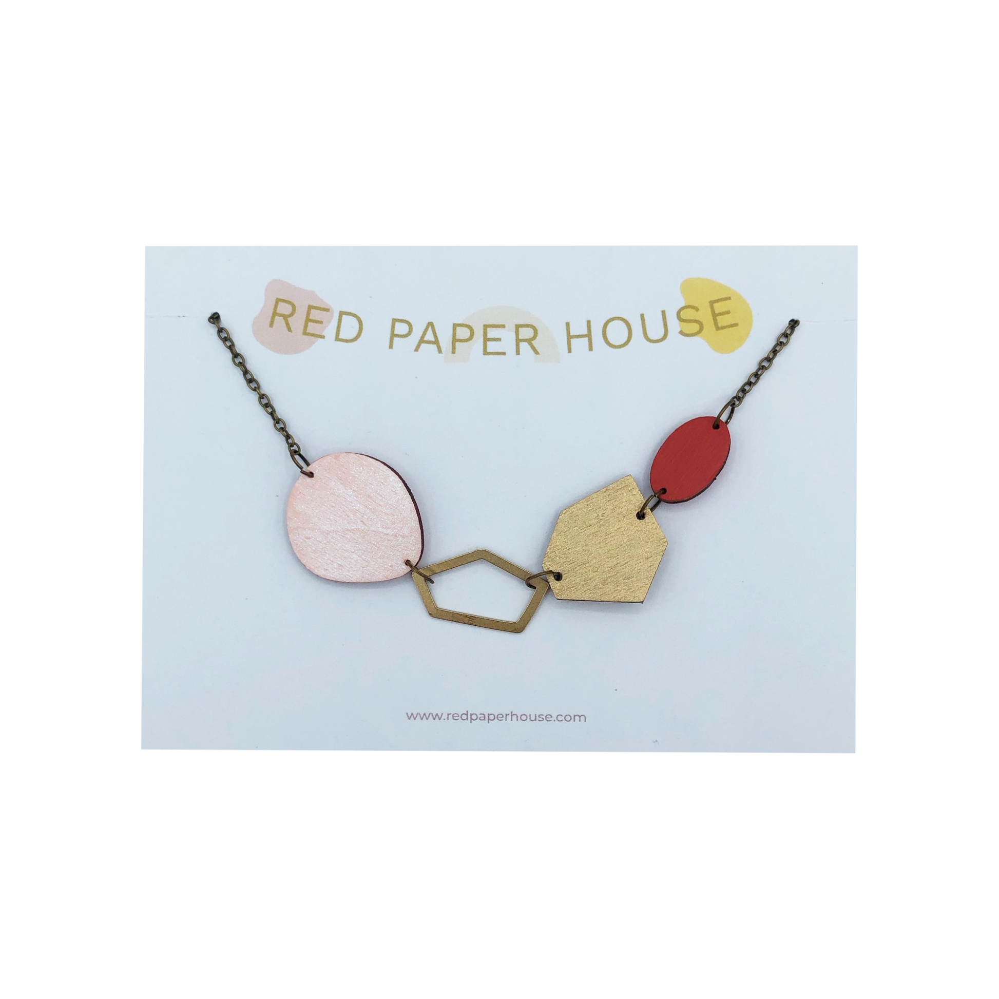 Necklace with geometric pendants on a 'Red Paper House' branded card