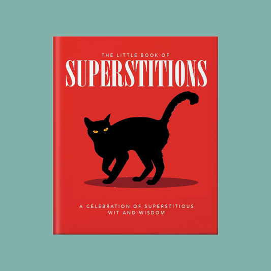 The cover of 'The Little Book of Superstitions' featuring a red background with a silhouette of a black cat and the title text.