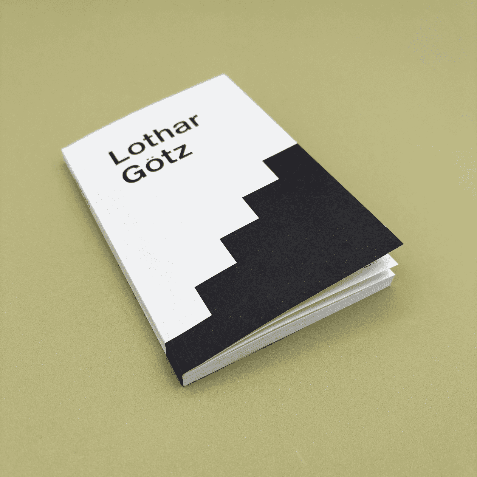 Book with black and white cover on a beige background