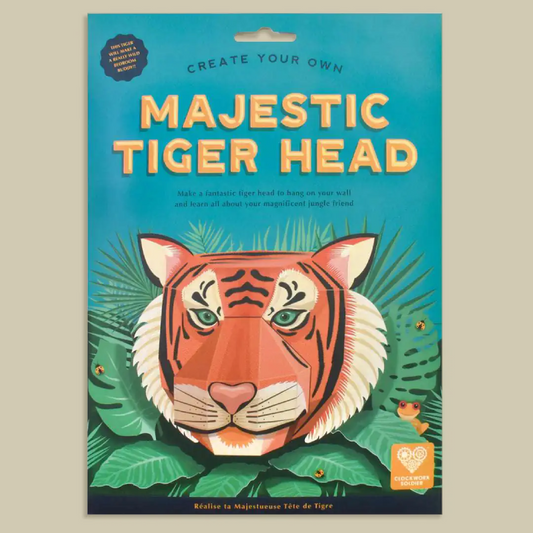 A flat-lay product shot of a cardboard craft kit package titled 'Majestic Tiger Head' with a colorful illustration of a tiger head surrounded by green leaves on a turquoise background.