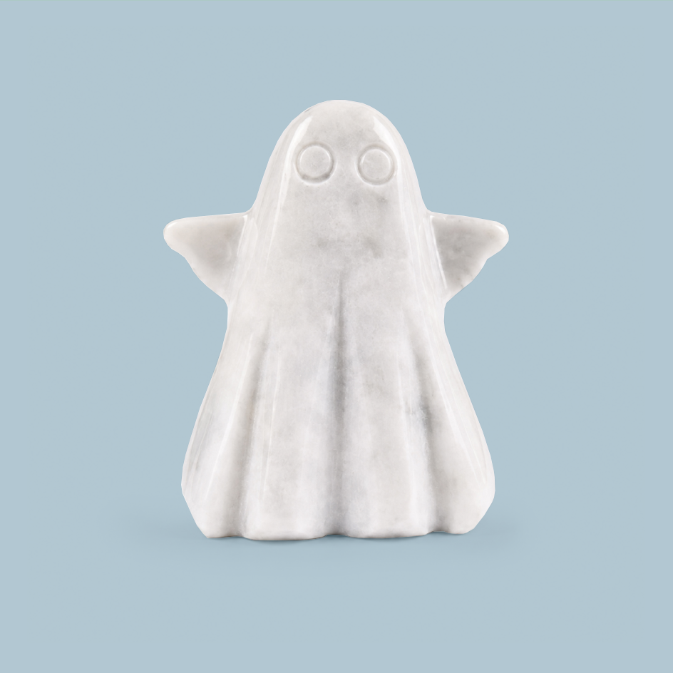 A small white ghost figurine with simple circular eyes and folded wings, centered on a light blue background.