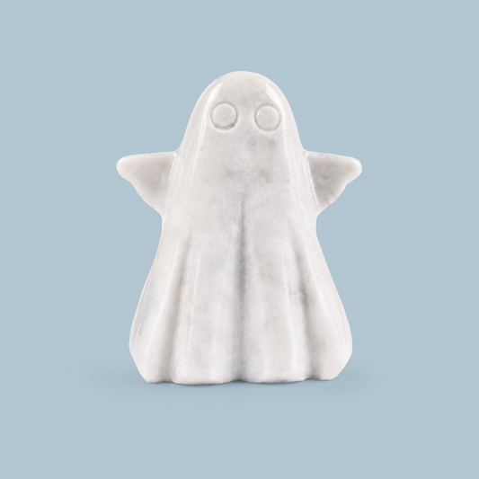 A small white ghost figurine with simple circular eyes and folded wings, centered on a light blue background.