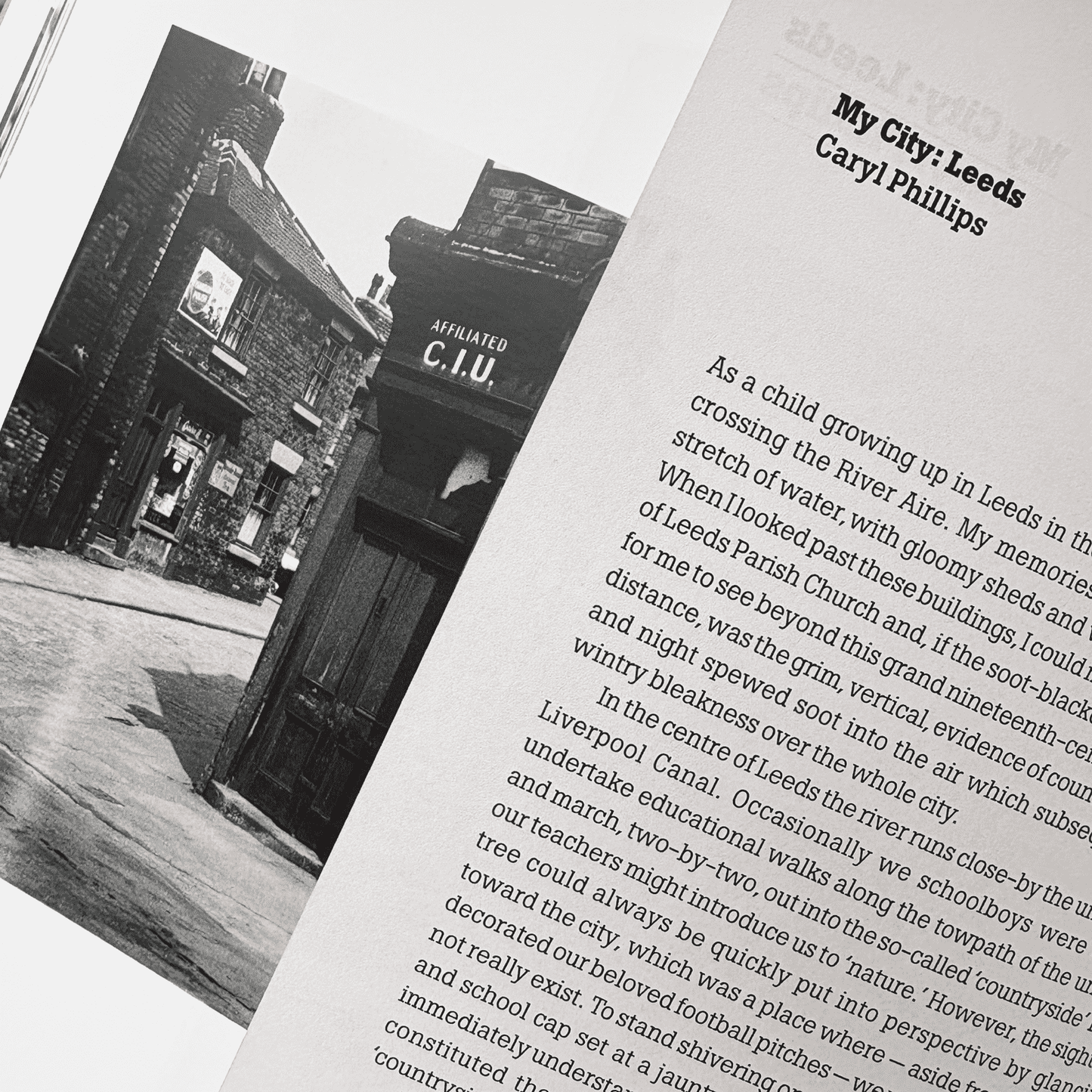 Book open to a page with text and a black and white photograph of a building.