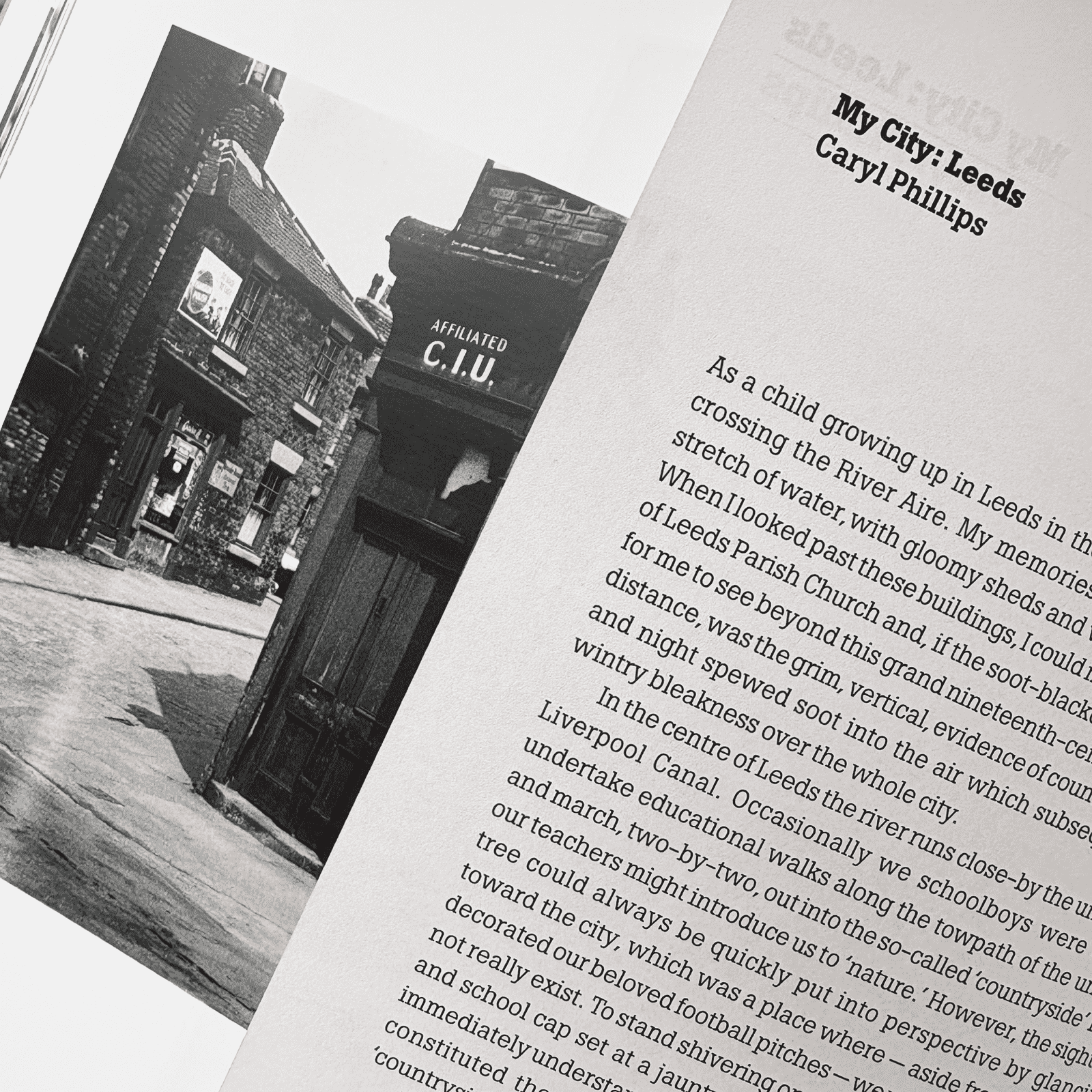 Book open to a page with text and a black and white photograph of a building.