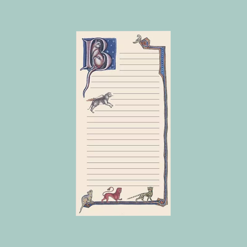 A lined notepad with a medieval-style illustrated border and initial letter, shown centered on a solid pale blue-green background.