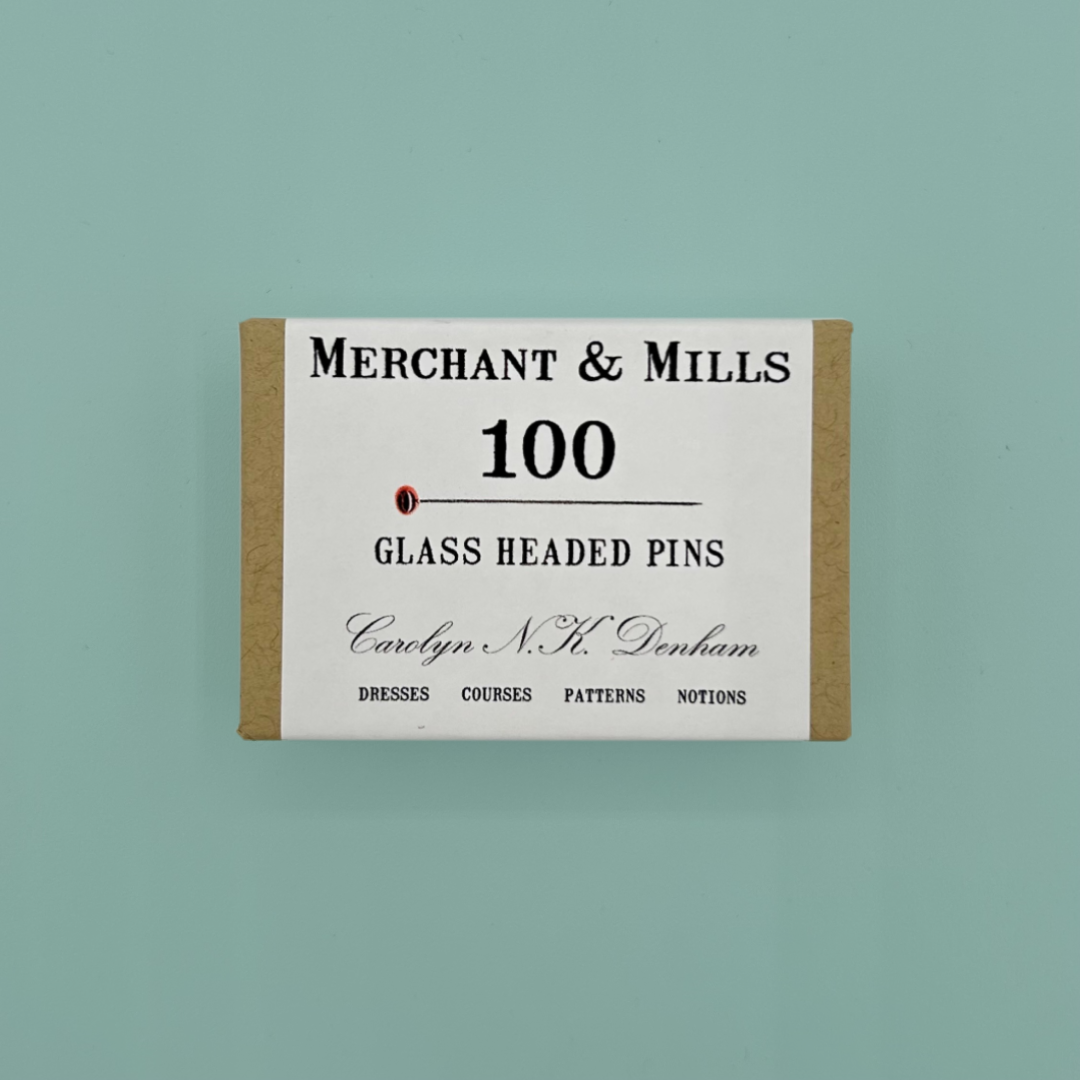 Box of Merchant & Mills glass headed pins on a light green background