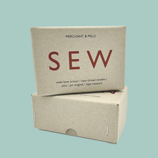 Two cardboard boxes with 'SEW' branding on a light blue background