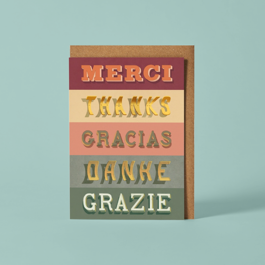 Multilingual 'Thanks' card with different languages on a light blue background