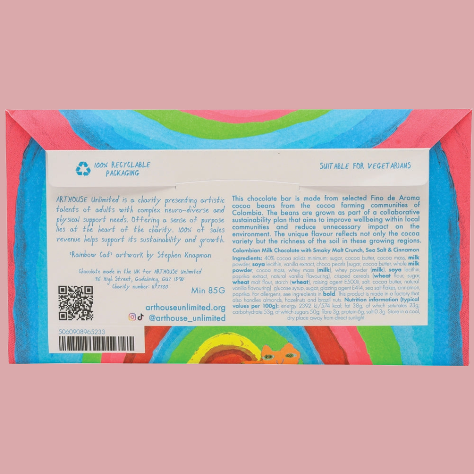 The back of a colourful chocolate bar wrapper, featuring a white text panel with ingredients, barcodes, and social media details, framed by a bright multicolor border on a pink background.