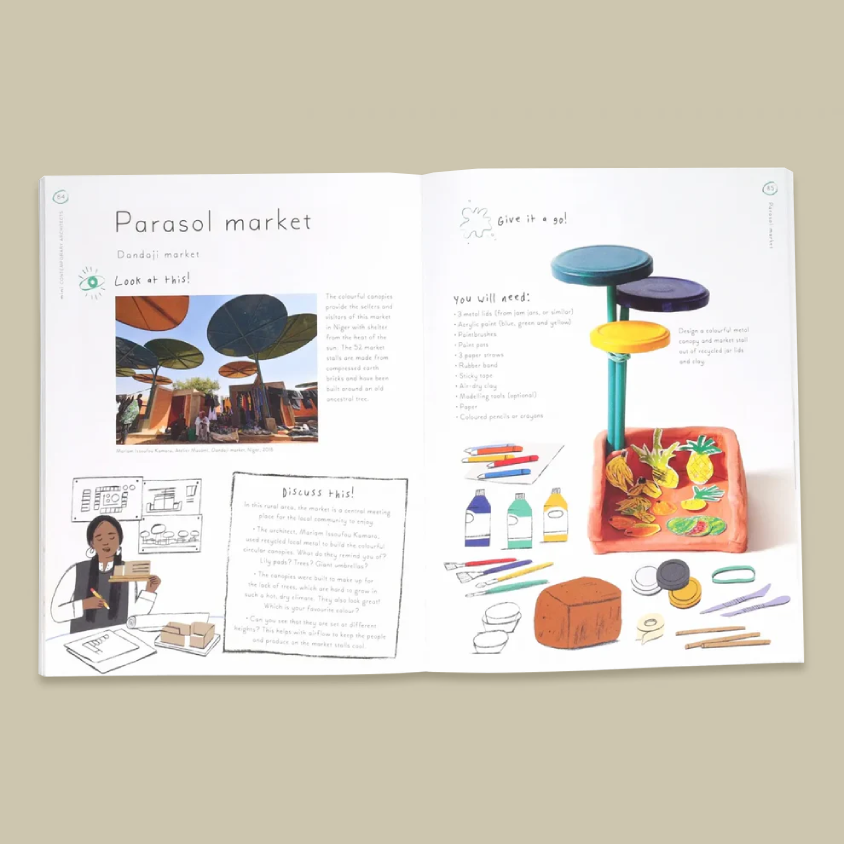 An open printed book spread titled 'Parasol market' on a plain beige background. The pages contain text, small illustrations, and a colourful drawing of a toy-like market setup with shelves, fruit, bottles, and accessories.