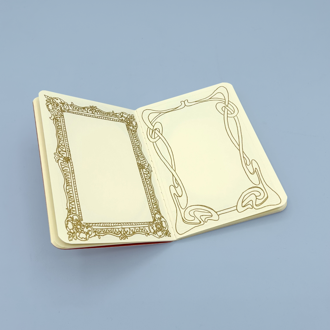 Decorative notebook with ornate gold design on a light blue background