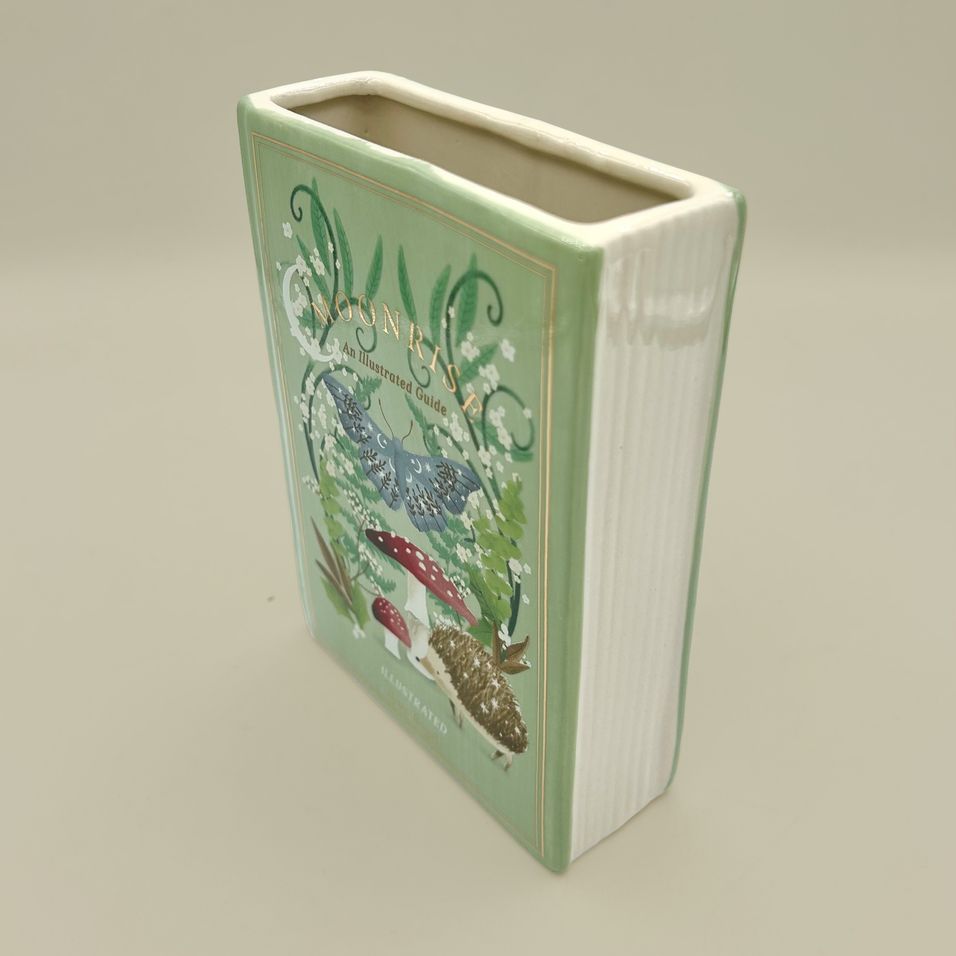 Rectangular ceramic vase with floral design on a beige background