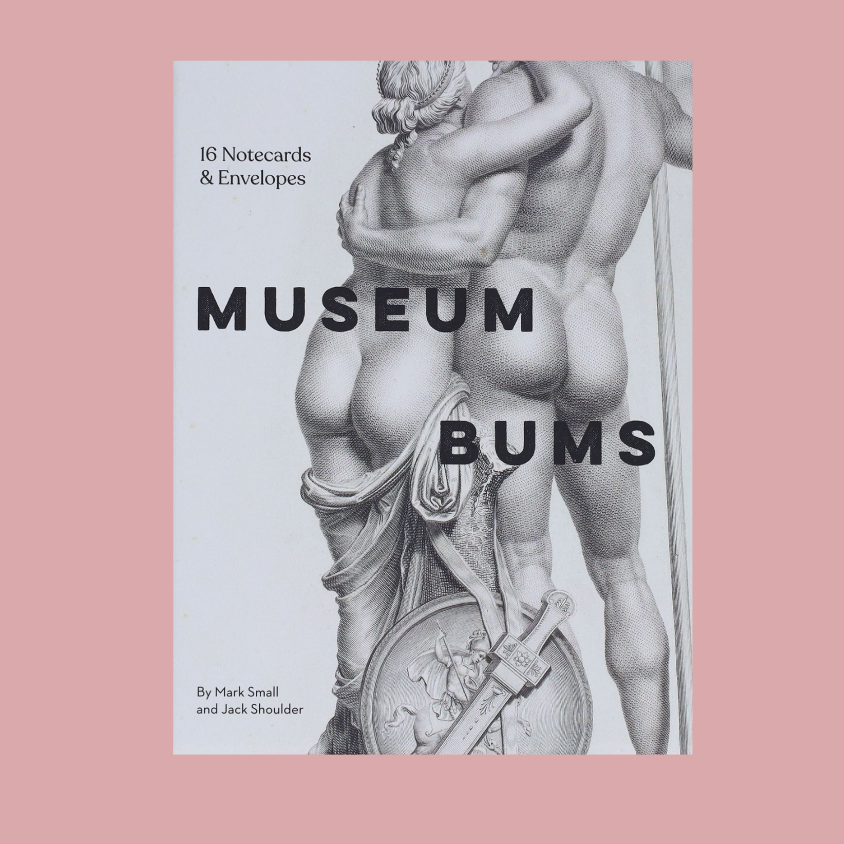 A book cover for 'Museum Bums: 16 Notecards & Envelopes' by Mark Small and Jack Shoulder, featuring a black and white classical sculpture of two embracing figures on a white background, centered on a dusty pink backdrop.